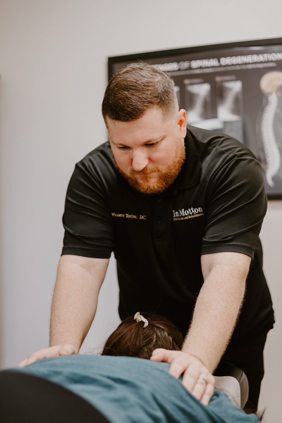 Dr. Torina treating a patient's back at In Motion in Oviedo, FL