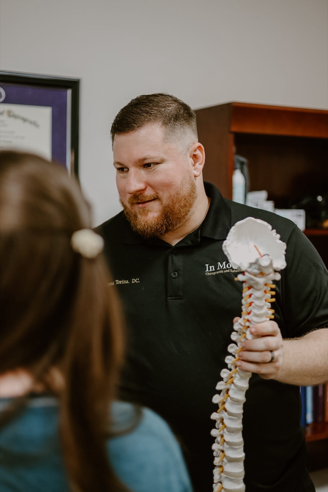 Dr. Torina in consultation with a patient at In Motion in Oviedo