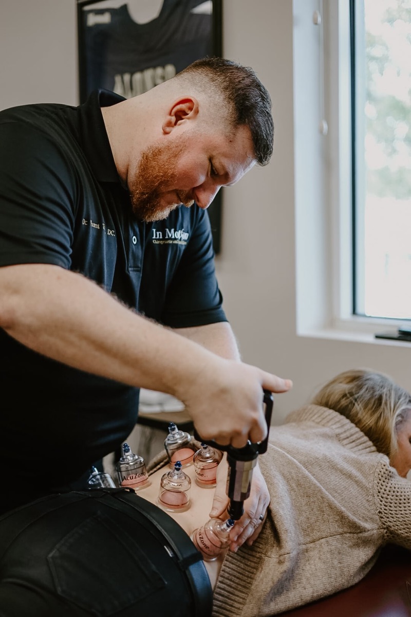 Dr. Torina performing cupping therapy on a patient at In Motion in Oviedo