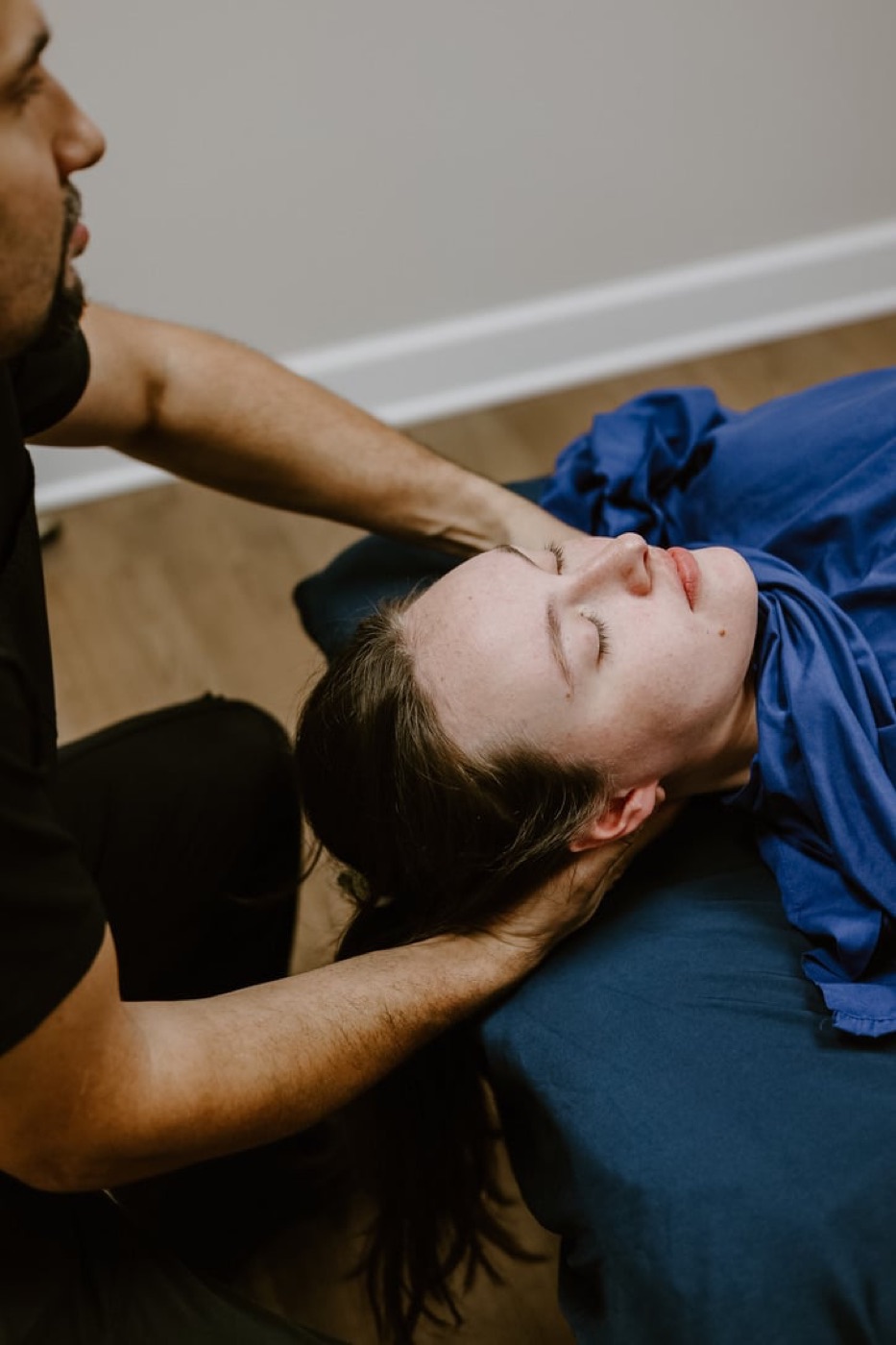 Hands-on upper neck treatment for headache relief at In Motion in Oviedo, FL